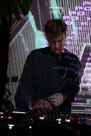 Live performer at Electronic Live Sessions in front of projected visuals