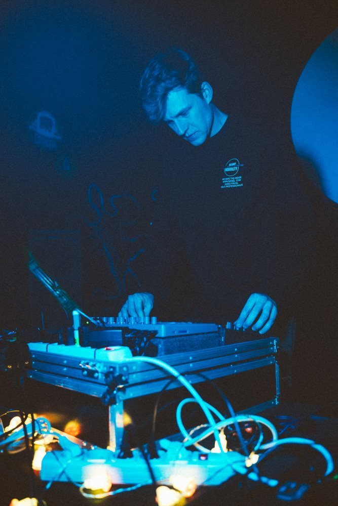 Musician playing hardware gear in blue light at Scena Chmielna